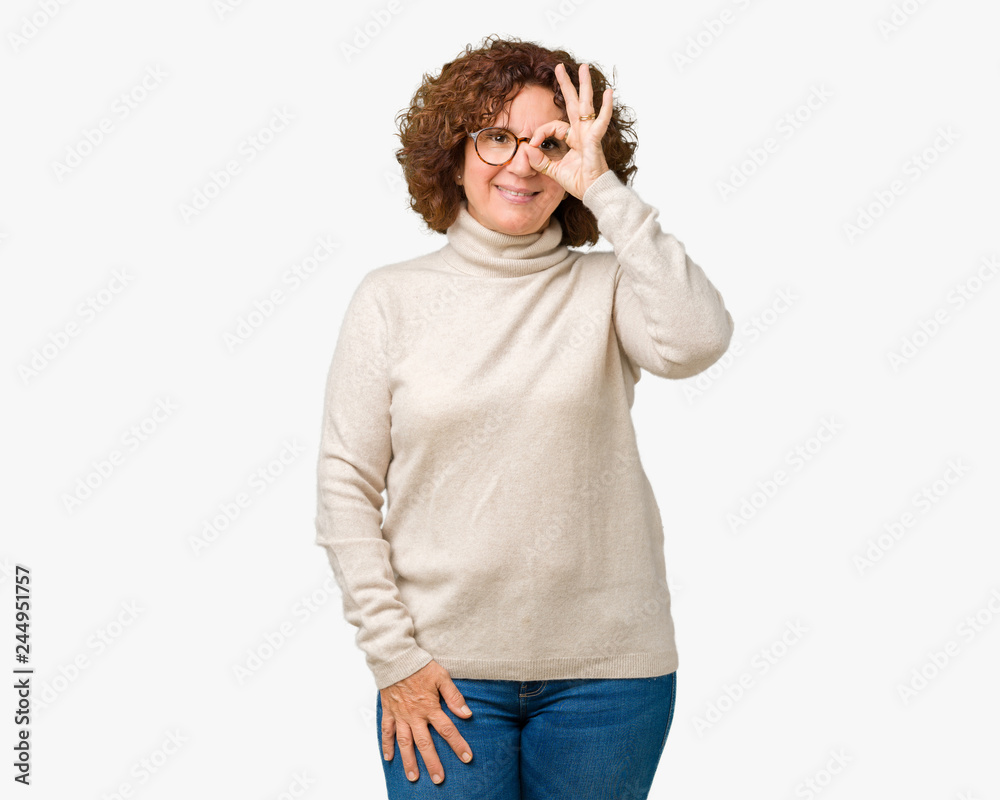 Beautiful middle ager senior woman wearing turtleneck sweater and glasses over isolated background doing ok gesture with hand smiling, eye looking through fingers with happy face. Beautiful middle ager senior woman wearing turtleneck sweater and glasses over isolated background doing ok gesture with hand smiling, eye looking through fingers with happy face.