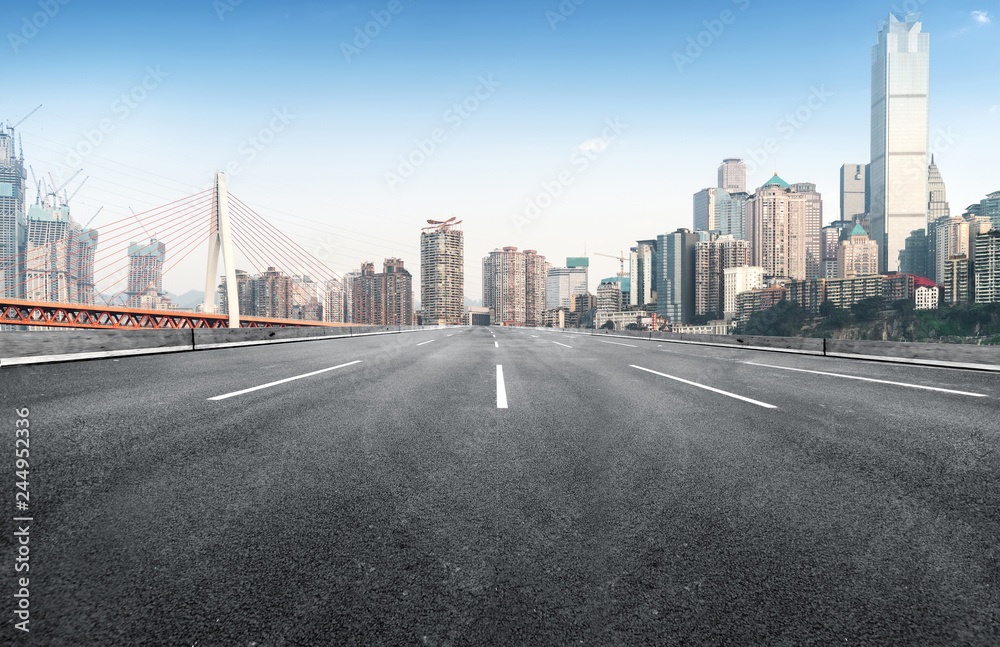 The expressway and the modern city skyline are in Chongqing, China.