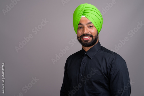 Young Indian Sikh businessman wearing green turban