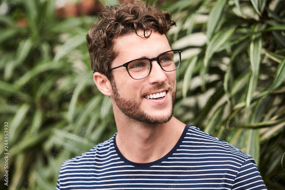 Smiling guy in glasses, looking away Smiling guy in glasses, looking away