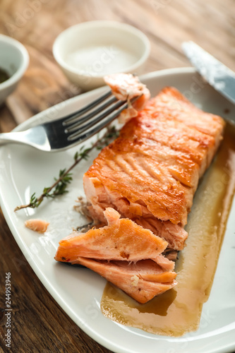 Eating of tasty grilled salmon, closeup