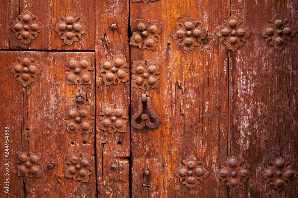 beautiful wooden door. Texture of vintage wooden door and door hammer