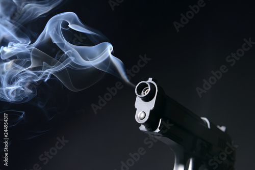 Smoking gun on dark background
