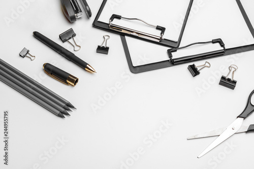 Clipboard with white sheet and pen isolated on a white background. Top view