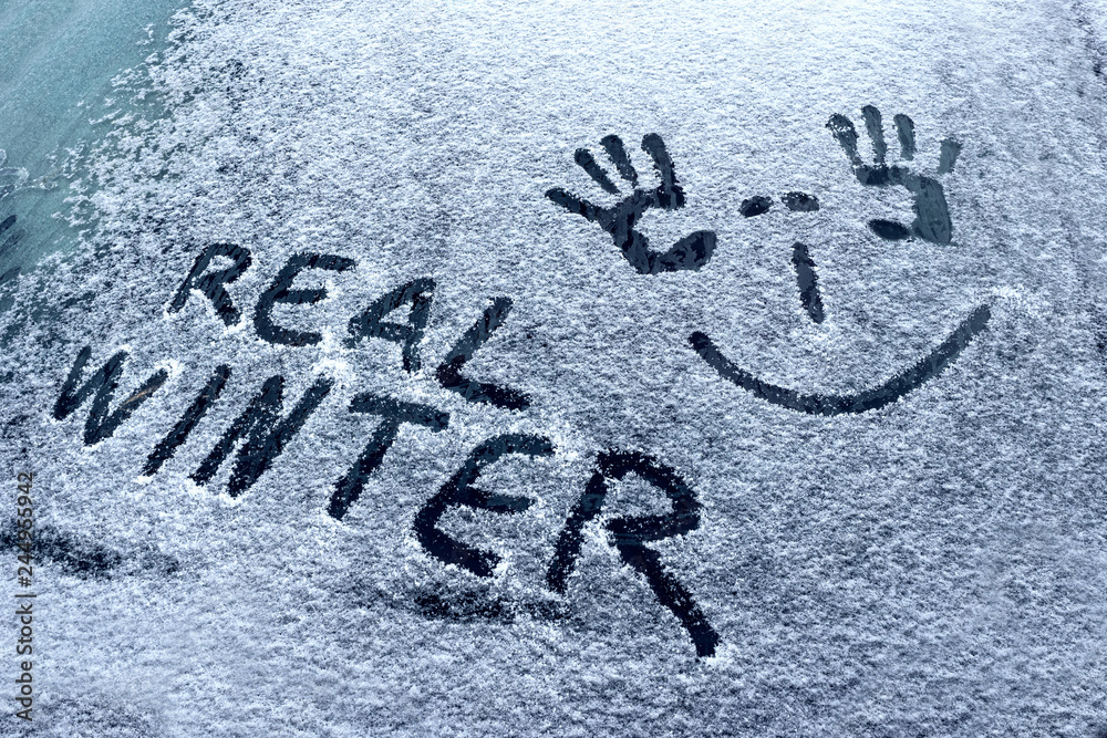 Closeup of wipers and frosted car windshield covered with ice and snow. Winter weather, transportation concept Closeup of wipers and frosted car windshield covered with ice and snow. Winter weather, transportation concept