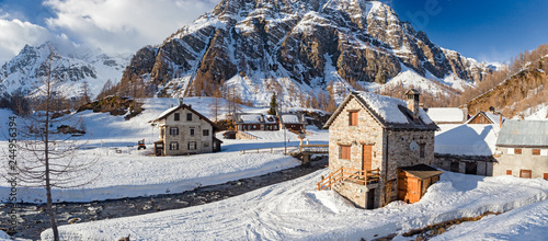 Panoramic view of the sunny snow-covered landscape of the village of Crampiolo, above the Alpe Devero in Piedmont, Italy. photo