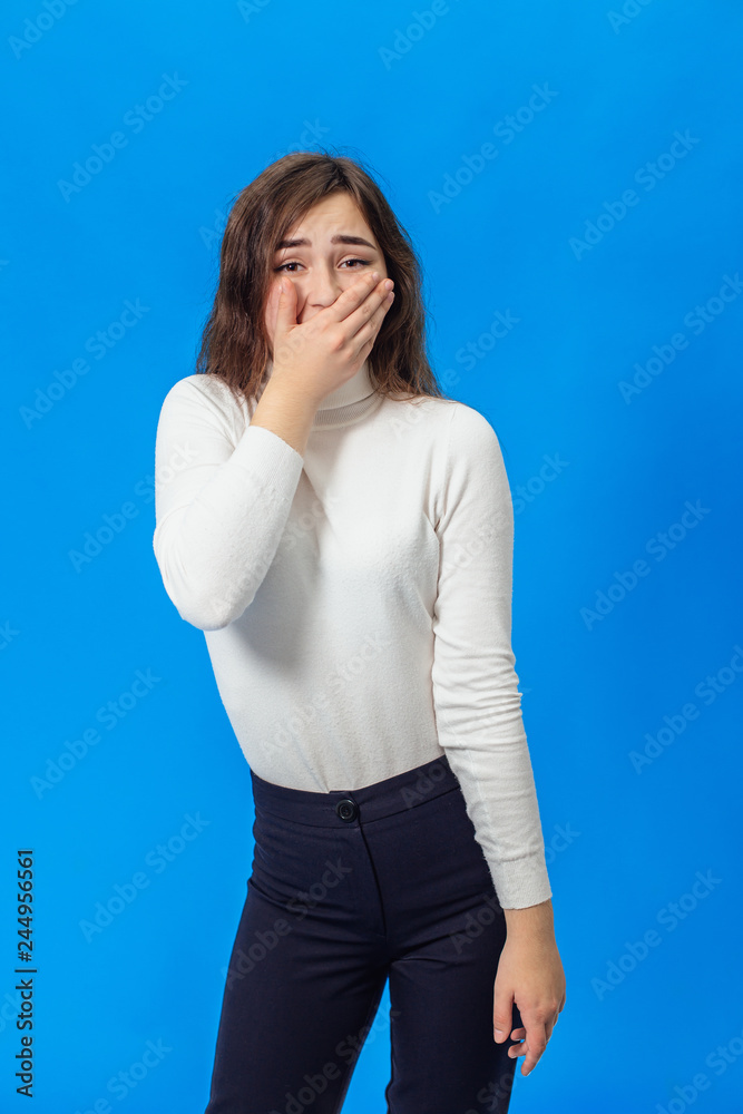 Young beautiful girl isolated on blue background Young beautiful girl isolated on blue background