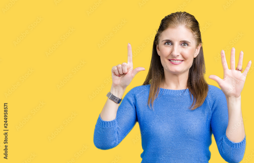 Beautiful middle age mature woman wearing winter sweater over isolated background showing and pointing up with fingers number seven while smiling confident and happy. Beautiful middle age mature woman wearing winter sweater over isolated background showing and pointing up with fingers number seven while smiling confident and happy.
