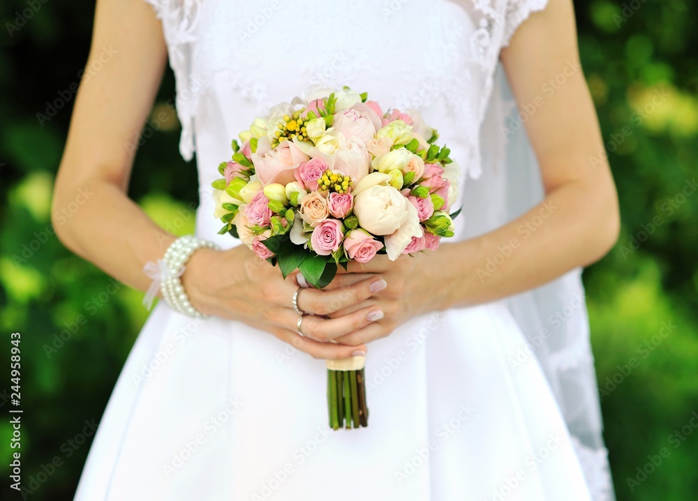 Bride holding wedding bouquet in hands Bride holding wedding bouquet in hands