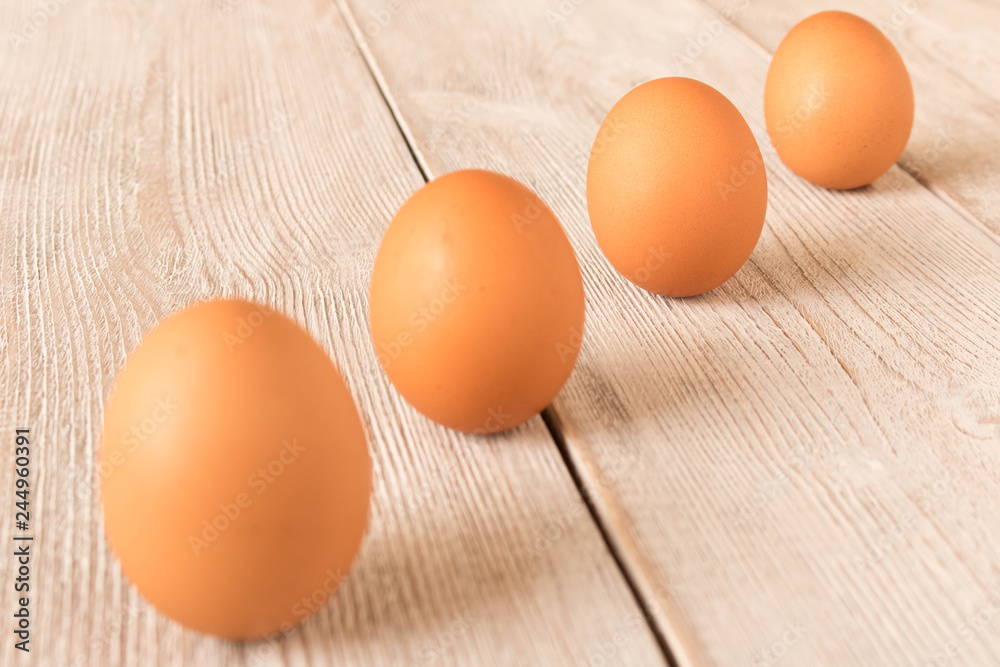 Chicken eggs on a wooden table. Selective focus. Chicken eggs on a wooden table. Selective focus.