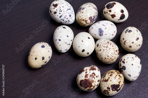 Quail eggs. Lie on a dark background.