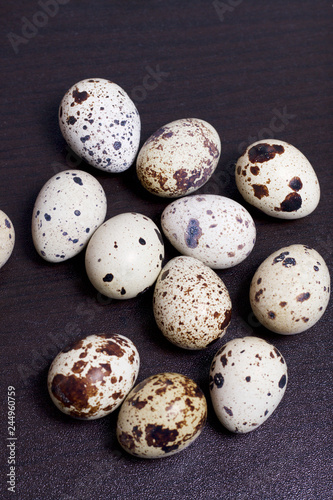 Quail eggs. Lie on a dark background.