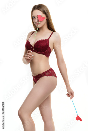 Photography girl holds heart, young girl in burgundy underwear holding hearts