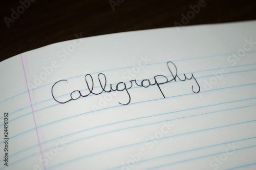 "calligraphy" word written in a practice notebook to improve students and child handwriting letter