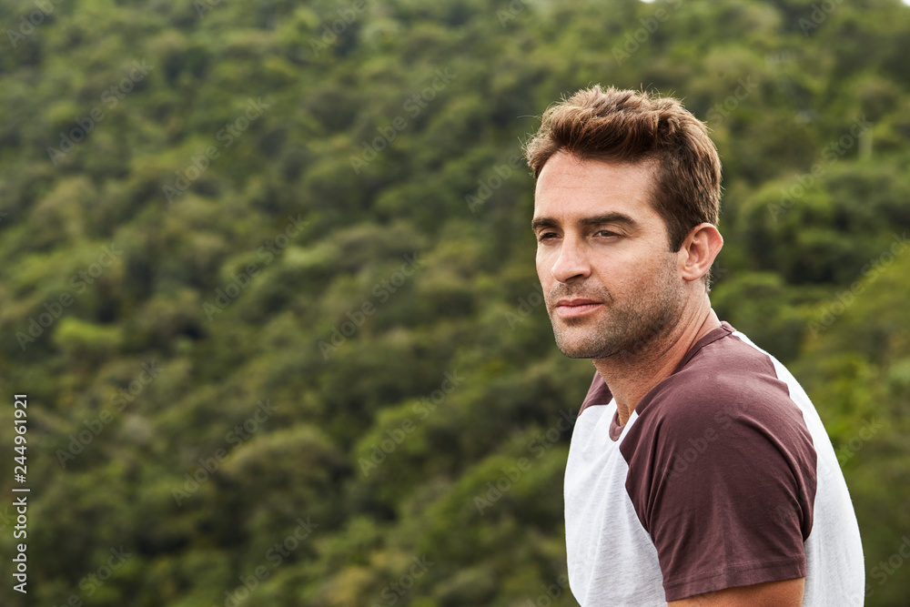 Serious man in t-shirt looking at view Serious man in t-shirt looking at view