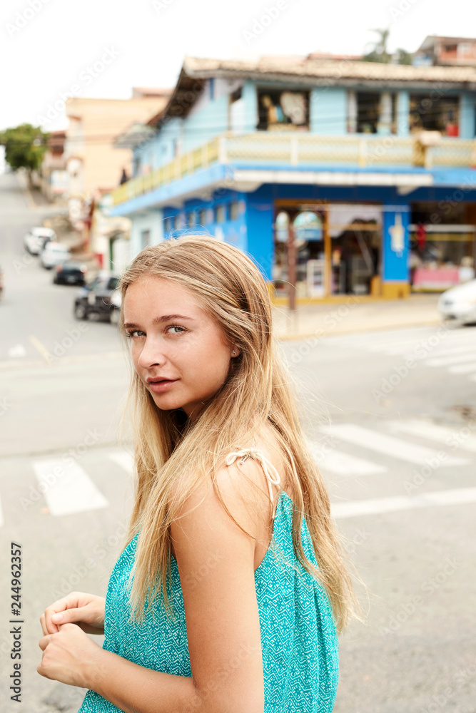 Portrait of town girl looking at camera in street