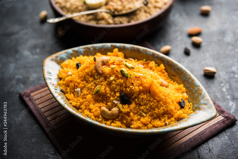 Badaam kesar shira / Sheera or almond saffron halwa, popular Indian dessert served in a bowl. selective focus