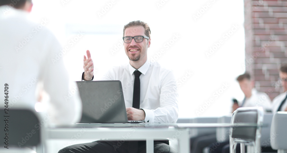employee talking with a colleague in the workplace in the office employee talking with a colleague in the workplace in the office