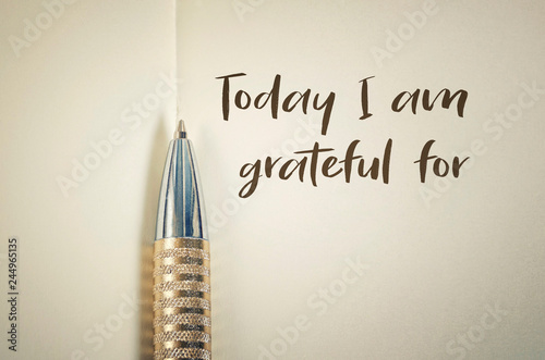 Close up of gratitude word with pen on notebook