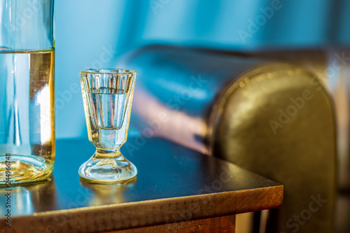 a bottle and a glass of alcohol are on a table