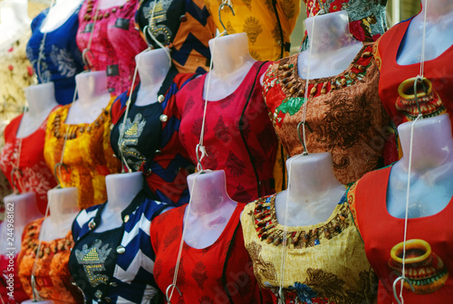 view of mannequins dressed in latest indian woman fashion dress salwar kameez in display,  in front of a retail shop photo