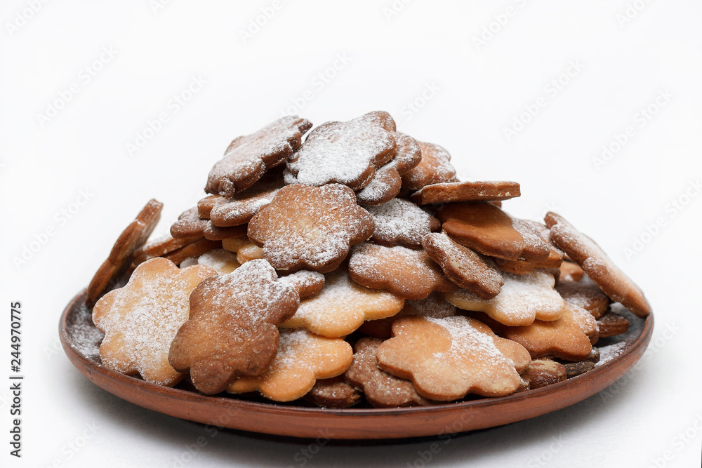 Original cookie flowers dusted with icing sugar on a white background isolated Original cookie flowers dusted with icing sugar on a white background isolated