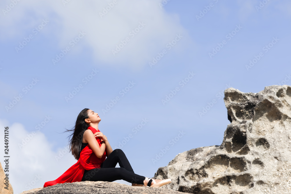 Ballerina in nature,Student woman practice ballet outdoor,stone background.Health lifestyle image.