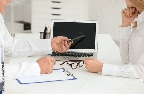 Male doctor consulting patient in clinic, closeup