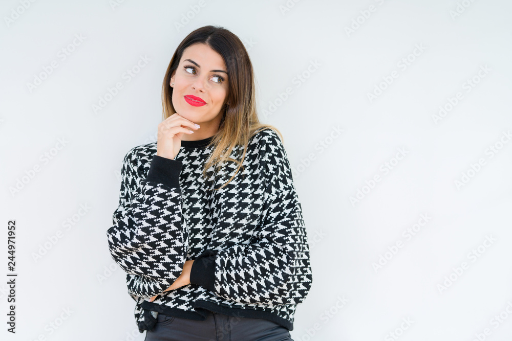 Young woman wearing casual sweater over isolated background with hand on chin thinking about question, pensive expression. Smiling with thoughtful face. Doubt concept. Young woman wearing casual sweater over isolated background with hand on chin thinking about question, pensive expression. Smiling with thoughtful face. Doubt concept.