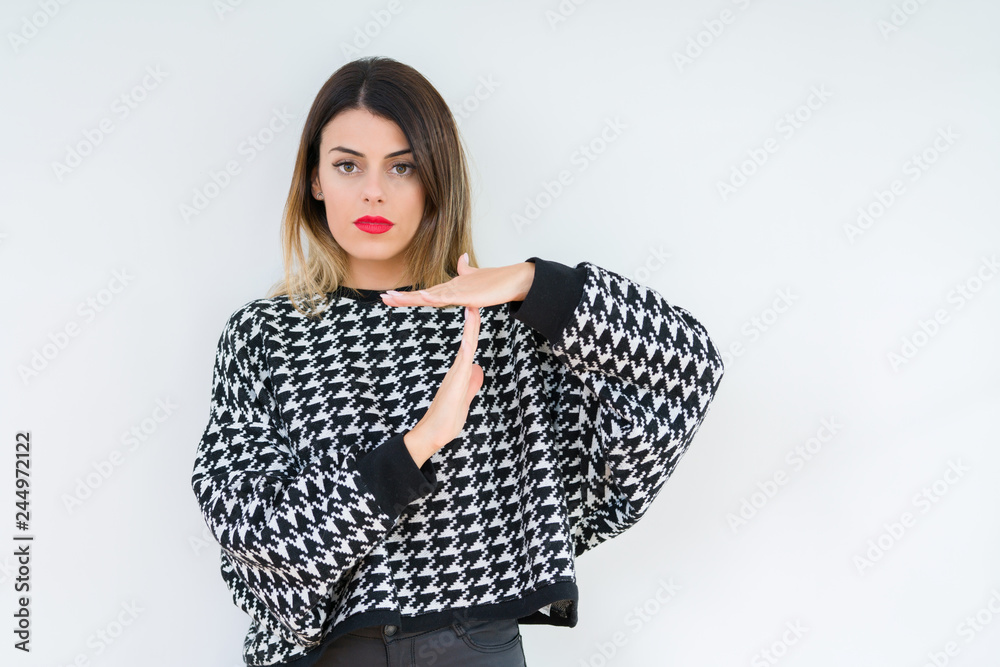Young woman wearing casual sweater over isolated background Doing time out gesture with hands, frustrated and serious face Young woman wearing casual sweater over isolated background Doing time out gesture with hands, frustrated and serious face