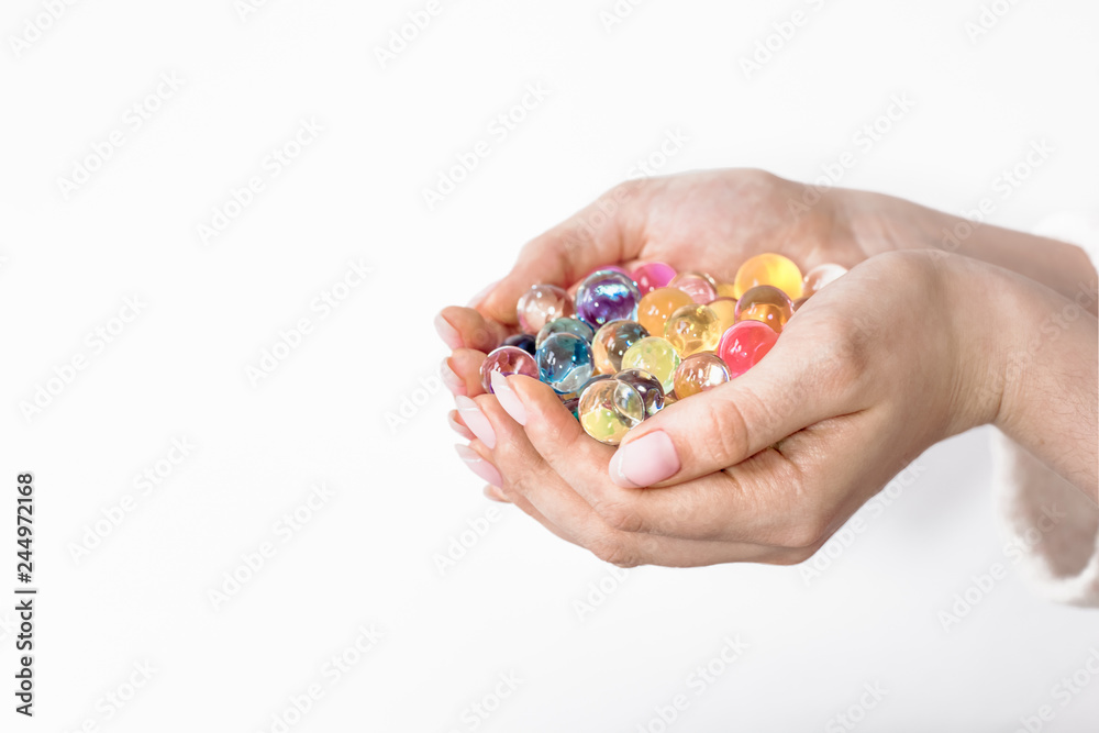 Growing-water-ball in hand, orbiz in hands isolated on white background, different colors Growing-water-ball in hand, orbiz in hands isolated on white background, different colors