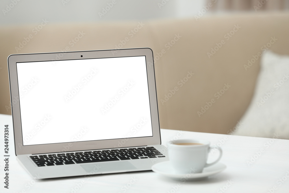 Fototapeta premium Laptop with blank screen on table indoors. Space for text