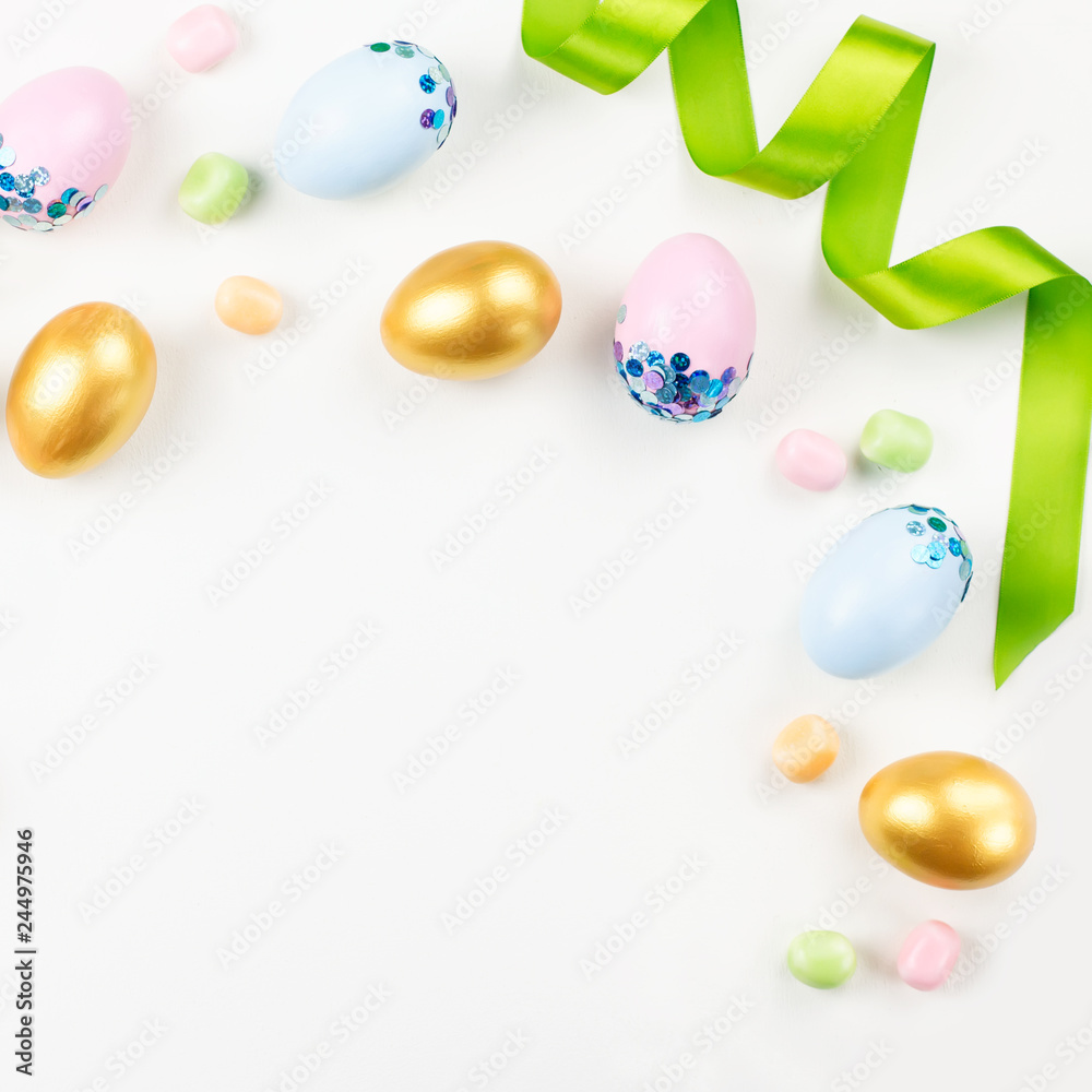 Obraz premium Festive Easter background with decorated eggs, flowers, candy and ribbons in pastel colors on white. Copy space