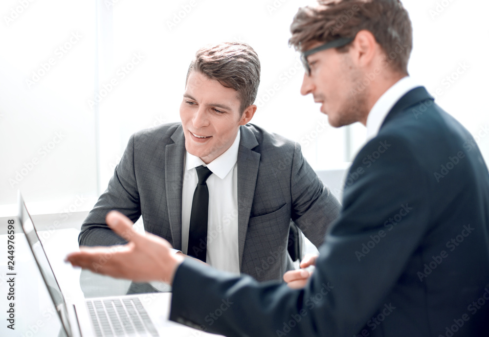 two businessmen use a laptop in the office two businessmen use a laptop in the office