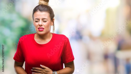 Young beautiful woman over isolated background with hand on stomach because indigestion, painful illness feeling unwell. Ache concept.