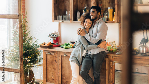 Young loving couple having good time at christmas morning