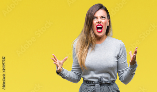Young beautiful worker business woman over isolated background crazy and mad shouting and yelling with aggressive expression and arms raised. Frustration concept.