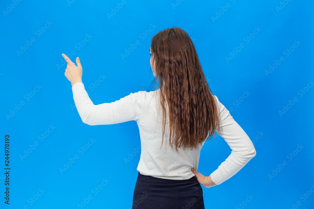Fototapeta premium Young beautiful girl isolated on blue background