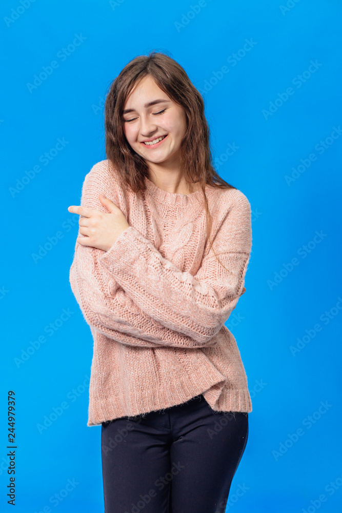 Young beautiful girl isolated on blue background Young beautiful girl isolated on blue background