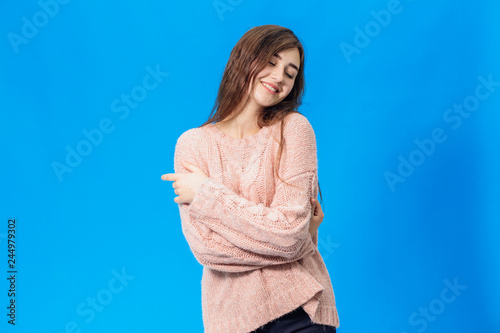 Young beautiful girl isolated on blue background