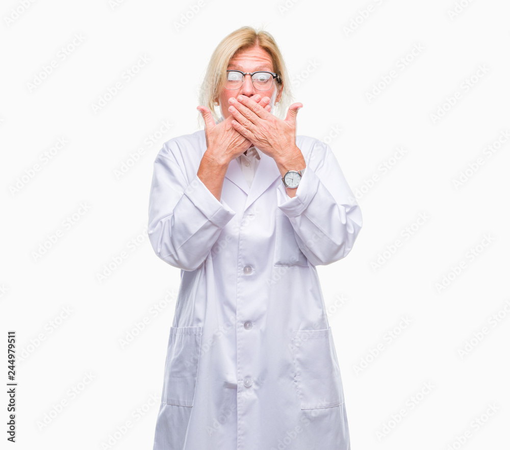 Middle age blonde therapist woman wearing white coat over isolated background shocked covering mouth with hands for mistake. Secret concept. Middle age blonde therapist woman wearing white coat over isolated background shocked covering mouth with hands for mistake. Secret concept.