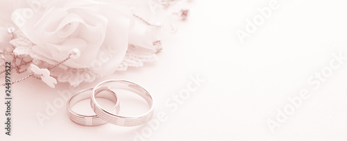 Foto Wedding rings on wedding card on a white background, border design panoramic ban