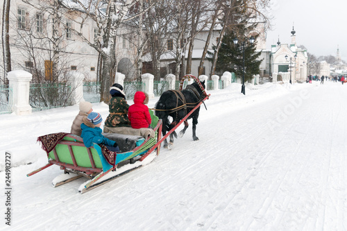 Fotografie Winter holiday New Year's (Christmas) sleigh rides harnessed by horses (sledding