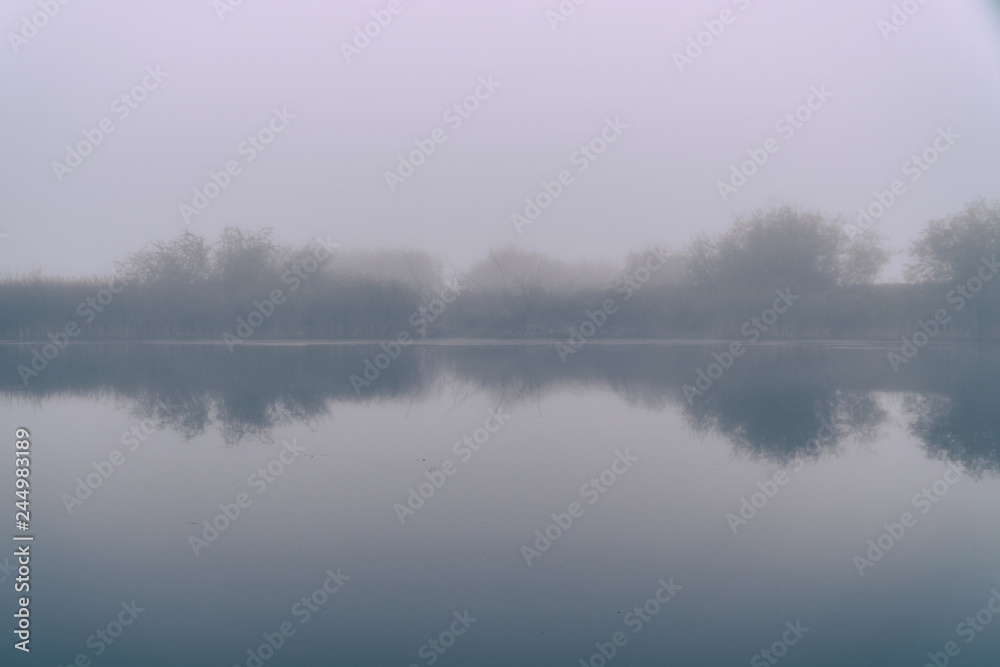 Fog in the early morning on a small lake