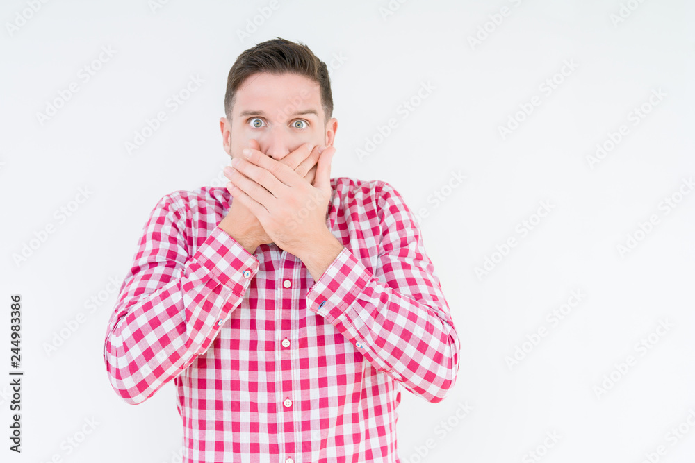 Young handsome man wearing shirt over isolated background shocked covering mouth with hands for mistake. Secret concept. Young handsome man wearing shirt over isolated background shocked covering mouth with hands for mistake. Secret concept.