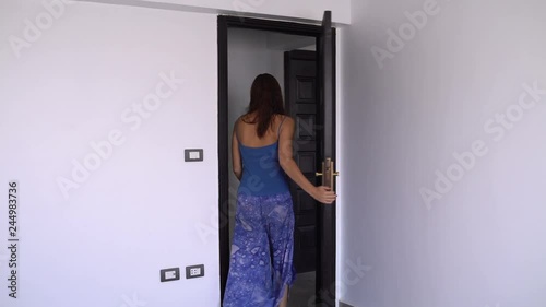 Woman turns off the light opens the door and leaves the room