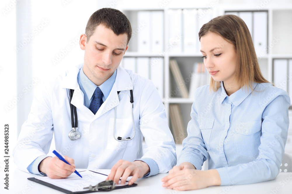 Doctor and  patient  sitting at the desk. Medicine and health care concept