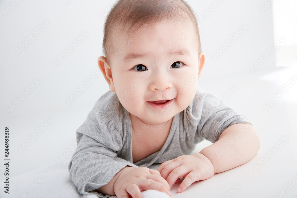 Closeup Asian baby lying on the clean ground Closeup Asian baby lying on the clean ground