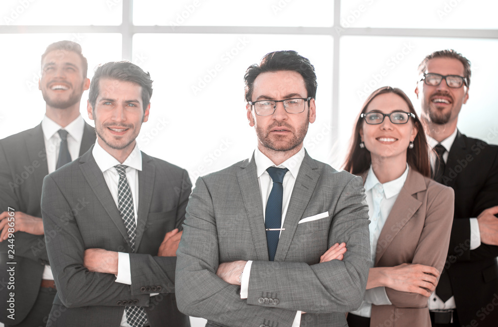 Happy business team with arms crossed at the office Happy business team with arms crossed at the office
