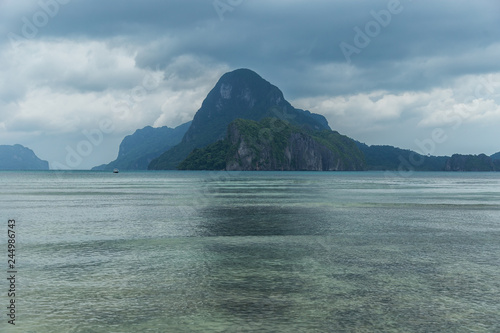 Landscape of Palawan, El Nido. Ocean and rock islands in background. Cloudy stormy sky. Philippines